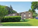 Two-story home with unique architectural features and lush landscaping at 3265 Tulip Dr, Indianapolis, IN 46227