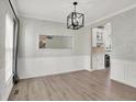 The dining room showcases wood floors, modern lighting, and seamless flow into the adjacent kitchen area at 3345 Kilkenny Cir, Carmel, IN 46032