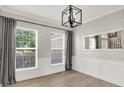 Stylish dining area features modern chandelier, large mirror, and natural light streaming through the windows at 3345 Kilkenny Cir, Carmel, IN 46032