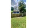 Spacious fenced backyard with a lush green lawn, offering ample space for outdoor activities at 3464 N Bancroft St, Indianapolis, IN 46218