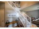 Inviting foyer with staircase, console table, and decorative sign at 3474 Glen Abbe Ct, Carmel, IN 46032