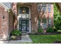 Close-up of brick home's front door with large arched window above at 3474 Glen Abbe Ct, Carmel, IN 46032