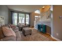 Cozy living room with comfortable seating, large windows, and a staircase at 3474 Glen Abbe Ct, Carmel, IN 46032