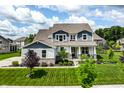 Lovely home boasts professional landscaping, a covered front porch, and a well-maintained lawn at 3606 Evergreen Way, Zionsville, IN 46077