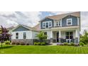Inviting two-story home featuring professional landscaping and a covered front porch at 3606 Evergreen Way, Zionsville, IN 46077
