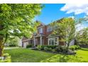Beautiful two-story brick home with attached garage and nicely landscaped yard at 3740 Weather Stone Xing, Zionsville, IN 46077
