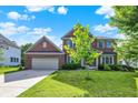 Lovely brick home with an attached garage and well-maintained lawn on a sunny day at 3740 Weather Stone Xing, Zionsville, IN 46077
