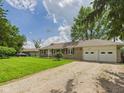 Lovely home featuring an expansive yard and two-car garage with a gravel driveway at 3809 N Glenwood Ave, Muncie, IN 47304