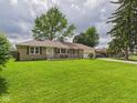 Quaint single-story home with a well-maintained lawn and an attached garage at 3809 N Glenwood Ave, Muncie, IN 47304