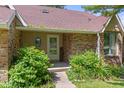 Inviting front entrance with a brick facade, featuring a 'Welcome' sign and lush landscaping at 396 W 500 S, Anderson, IN 46013