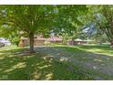 Spacious front yard with mature trees, showcasing the home's setting and curb appeal at 396 W 500 S, Anderson, IN 46013