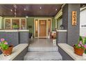 Inviting front porch with brick accents, decorative lighting, and cozy seating area at 4046 N Park Ave, Indianapolis, IN 46205