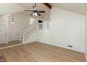 Spacious living room featuring new floors, staircase, and plenty of natural light at 4291 Caledonia Way, Indianapolis, IN 46254