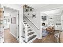 Hallway with staircase leading to the kitchen and living room with white built-in shelving at 4431 Cranbrook Dr, Indianapolis, IN 46250