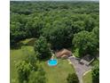 Expansive aerial view of home on a large lot with a pond, above-ground pool and two-car garage at 6295 State Road 142 Rd, Martinsville, IN 46151