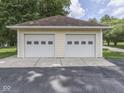 Exterior view of the two-car garage with white doors and siding at 6295 State Road 142 Rd, Martinsville, IN 46151
