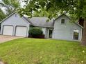 Charming home with a two-car garage, manicured lawn, and classic architectural design details at 7042 Colita More Ct, Indianapolis, IN 46254