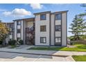 Condominium exterior featuring traditional siding, stairwell entry, and green space at 8158 Shorewalk Dr # F, Indianapolis, IN 46236