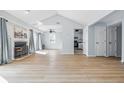 Bright living room with fireplace, hardwood floors, and easy access to kitchen and deck at 8158 Shorewalk Dr # F, Indianapolis, IN 46236