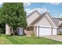 Beautiful exterior view of a charming home with a lush green lawn and mature trees creating a serene and inviting atmosphere at 829 Pioneer Woods Dr, Indianapolis, IN 46224