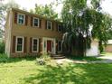 Charming home with red shutters, front garden area, and a classic design at 8425 E 82Nd E St, Indianapolis, IN 46256