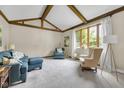 Cozy living room showcasing vaulted ceilings, exposed wood beams, and large windows at 8525 Winding Ridge Rd, Indianapolis, IN 46217