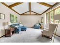 Bright living room featuring vaulted ceilings, exposed wood beams, and natural light at 8525 Winding Ridge Rd, Indianapolis, IN 46217