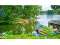 Beautiful backyard with direct lake access, featuring docks, boats, and lush greenery at 8635 S Providence Dr, Nineveh, IN 46164