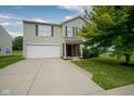 Two-story home features charming curb appeal, a two-car garage, and beautiful landscaping at 9775 Big Bend Dr, Indianapolis, IN 46234