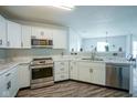 Well-lit kitchen with stainless steel appliances, white cabinets, and stylish countertops at 9775 Big Bend Dr, Indianapolis, IN 46234