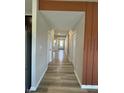 Inviting hallway with wood-look floors, neutral paint, and contemporary style at 10218 Arctic Edge Dr, Indianapolis, IN 46259