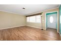 Bright room with wood floors, a large window, and freshly painted white trim at 10500 S County Road 200 W, Muncie, IN 47302