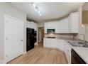Well-lit kitchen features white cabinetry, stainless steel appliances, and durable countertops at 11074 Galley Way, Fishers, IN 46040