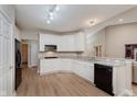 Well-lit kitchen features white cabinetry, stainless steel appliances, and durable countertops at 11074 Galley Way, Fishers, IN 46040