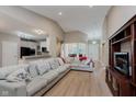 Bright, open-concept living room featuring vaulted ceilings, hardwood floors and neutral color palette at 11074 Galley Way, Fishers, IN 46040