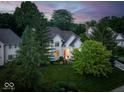 Stunning aerial view of a white two-story home surrounded by lush greenery at 12450 Petalon Trce, Fishers, IN 46037