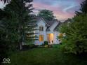 Charming white two-story home with manicured landscaping and inviting front porch at 12450 Petalon Trce, Fishers, IN 46037