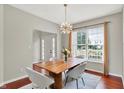 Inviting dining room featuring a wooden table with gray chairs and stylish light fixture at 13757 Flintridge Pass, Carmel, IN 46033