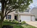 Charming two-story home features brick and vinyl siding, dark shutters, and a spacious three-car garage at 13859 Keams Dr, Fishers, IN 46038