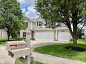 Charming two-story home features brick and vinyl siding, dark shutters, and a spacious three-car garage at 13859 Keams Dr, Fishers, IN 46038