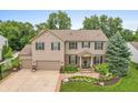A beautiful home with a large yard and mature trees, showcasing its curb appeal and setting at 1393 Turfway Dr, Avon, IN 46123