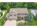 A large home in a serene setting, boasting a well-kept lawn, ample parking, and inviting curb appeal at 1393 Turfway Dr, Avon, IN 46123