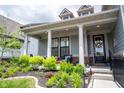 Inviting front porch with elegant columns and landscaping, perfect for relaxing at 1580 Mairn Ave, Carmel, IN 46032