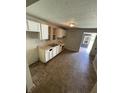 An eat-in kitchen featuring tile floors and basic white cabinets at 1902 Orange St, Indianapolis, IN 46203