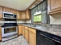Functional kitchen with stainless steel appliances, wood cabinets, and a practical double sink at 1980 S Arthur Rd, Paragon, IN 46166
