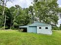 Exterior view of a spacious metal outbuilding with sliding doors, perfect for storage or workshop at 1980 S Arthur Rd, Paragon, IN 46166