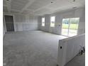 Large unfinished room with windows overlooking yard and slider at 235 Highland Ave, Danville, IN 46122