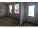 Unfinished room featuring bright windows and door to the exterior at 235 Highland Ave, Danville, IN 46122