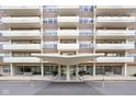 Inviting building entrance with a modern canopy, potted plants, and bench seating at 25 E 40Th St # Apt 1B/D, Indianapolis, IN 46205