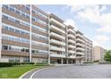 Brick apartment building with white balconies, lush lawn, and a circular driveway at 25 E 40Th St # Apt 1B/D, Indianapolis, IN 46205